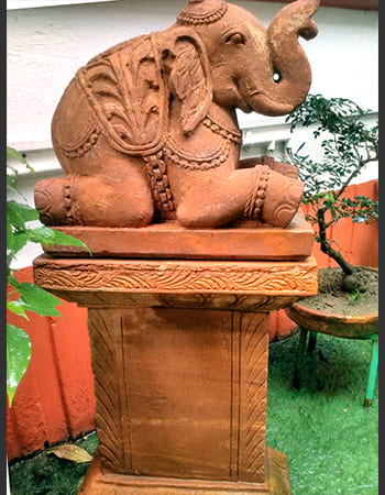Carved wooden pillar with intricate floral designs and traditional architectural elements