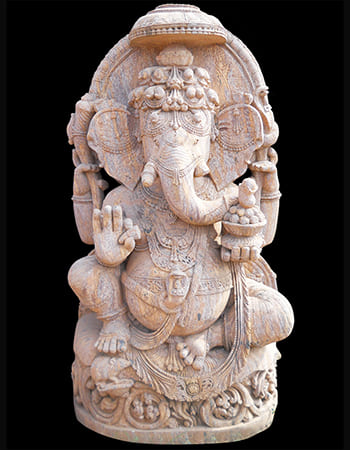 Elegant Ganesh idol in seated meditation pose with detailed lotus base and ornate jewelry carving