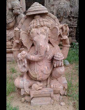 Traditional Lord Ganesh sculpture with blessing gesture and detailed trunk carving in natural stone