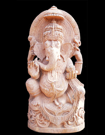 Divine Lord Ganesh statue with blessing mudra and intricately carved traditional costume details