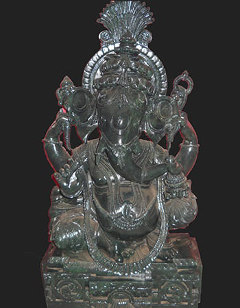 Graceful green stone carving of a female figure with flowing hair and elegant drapery