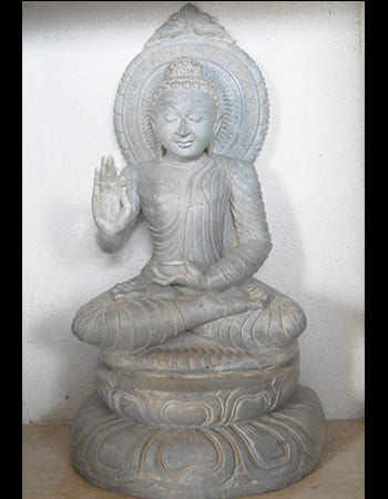 Beautiful green stone sculpture of a goddess with multiple arms and divine symbols