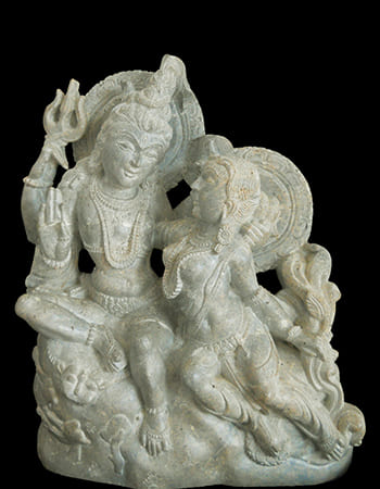 Refined green stone sculpture of a sage with meditation pose and serene facial expression