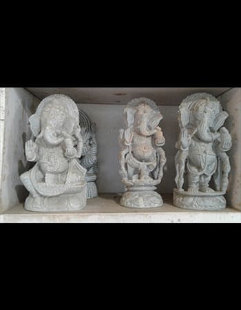 Intricate green stone artwork depicting a temple scene with architectural details and religious motifs