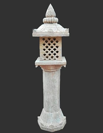 Traditional sandstone pillar light stand with ornate carved base and decorative motifs for outdoor garden illumination