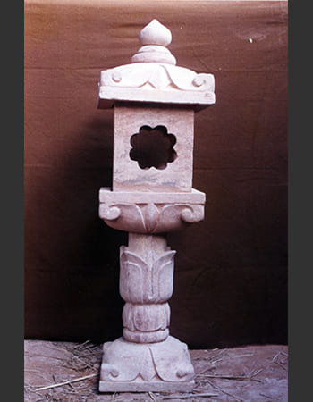 Artistic sandstone lamp stand with multi-tiered design and traditional carved patterns ideal for garden and patio lighting