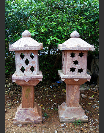 Heritage-style light post with detailed stone carving work featuring cultural motifs and sturdy sandstone construction
