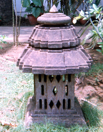 Ornamental garden light fixture with elaborate sandstone base featuring intricate relief work and weather-resistant finish