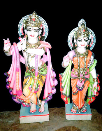 Elegant pink marble Balabhadra sculpture featuring detailed facial expressions and traditional ornamental patterns