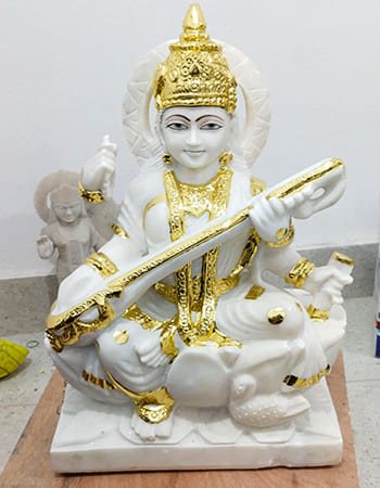 Detailed marble temple plaque featuring mythological scenes with fine carving work and spiritual symbolism