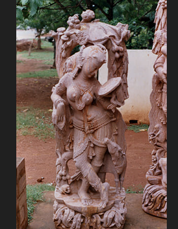 Sandstone Devadasi statue with traditional temple dancer pose and ornamental details