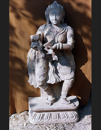 Traditional Devadasi sculpture in sandstone with intricate carving of dance costume and accessories