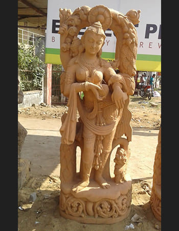 Traditional Devadasi statue in sandstone with detailed carving of classical dance posture