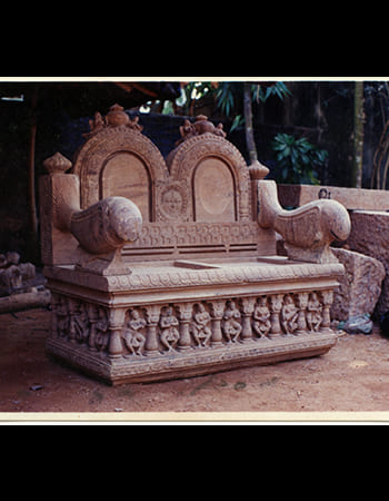 Traditional marble ceremonial vessel with carved handles and devotional patterns for temple rituals