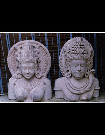 Shiva in Padmasana with Ganga flowing from hair, serene sandstone statue representing purification and divine grace